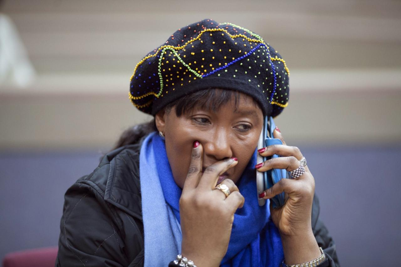 'Makaziwe Mandela, daughter of former South African President Nelson Mandela, talks on her mobile phone during the final court hearing concerning the removal of the remains of the former leader\'s chi