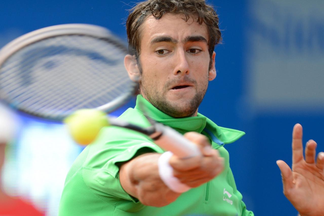 'Croatia\'s Marin Cilic returns the ball against Russia\'s Mikhail Youzhny during their ATP tennis BMW Open quarter final match in Munich, southern Germany, on May 4, 2012. AFP PHOTO/CHRISTOF STACHE'