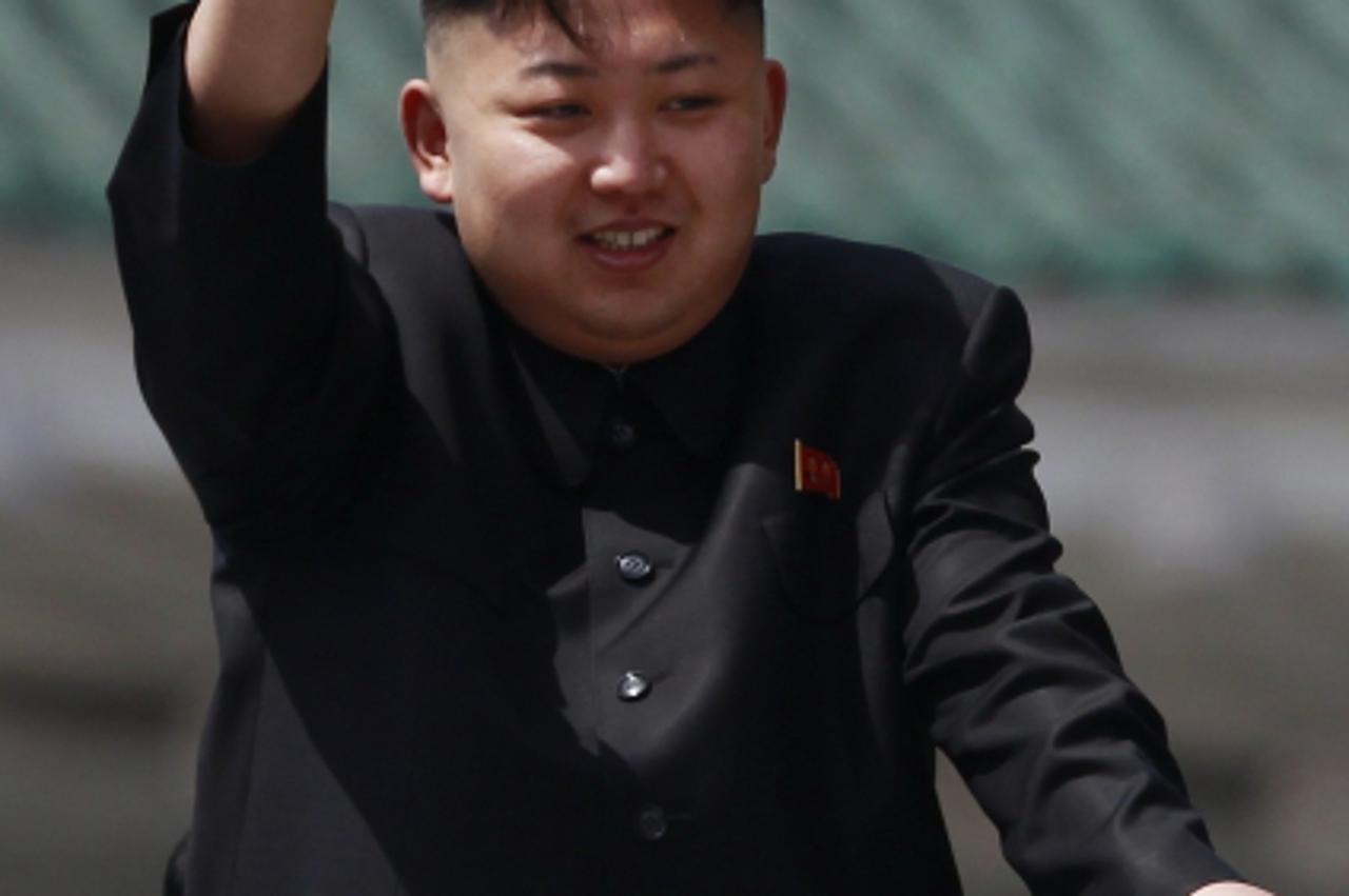 'North Korea leader Kim Jong-un waves to the crowd during a military parade to celebrate the centenary of the birth of North Korea founder Kim Il-sung in Pyongyang April 15, 2012. REUTERS/Bobby Yip (N