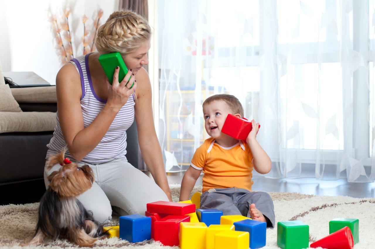 mother and kid boy role-playing together indoor