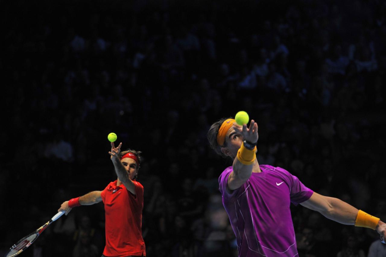 'This multiple exposure image shows Switzerland\'s Roger Federer (L) and Spain\'s Rafael Nadal preparing to serve during their singles final tennis match, on the last day of the ATP World Tour Finals,