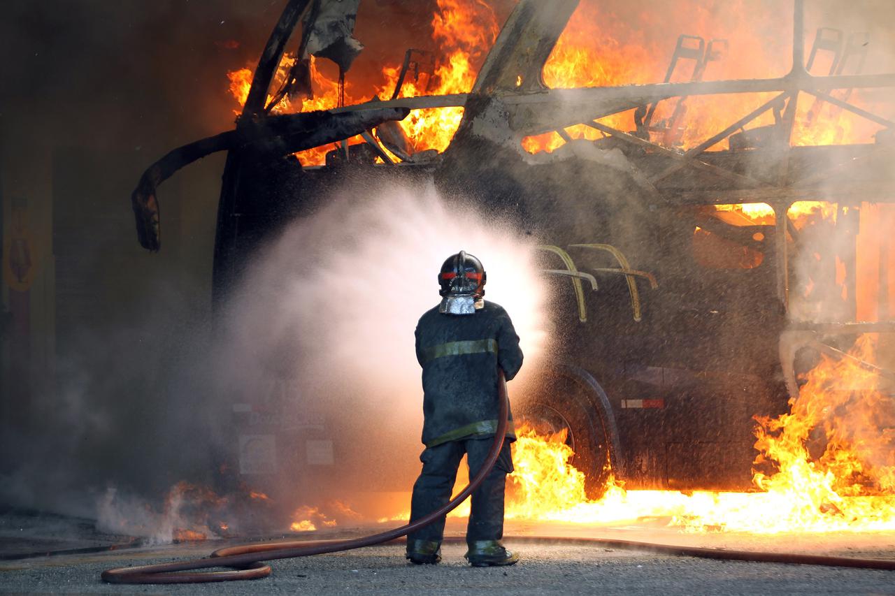 Firefighters try to extinguish the flames of a bus that caught fire inside a garage in Marginal Tiete, northern Sao Paulo, Brazil, on Wednesday, November 21, 2012. There were no injuries reported. Photo: HELVIO  ROMERO/ESTADAO CONTEUDO/DPA/PIXSELL
