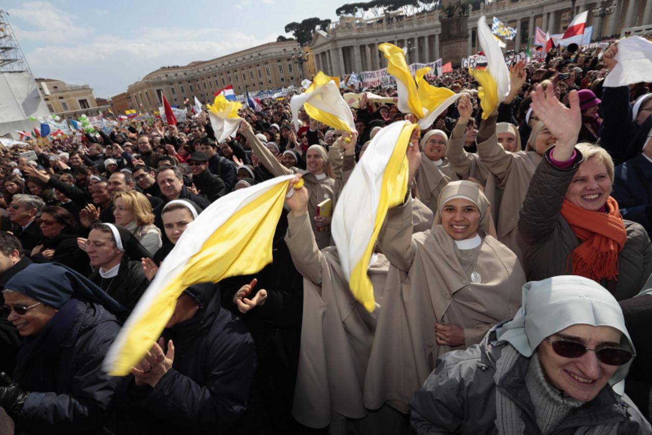 'Nuns wave at Pope Benedict XVI during the Angelus in Saint Peter's Square at the Vatican February 24, 2013. Pope Benedict, speaking in his last Sunday address before his resignation, said he was fol