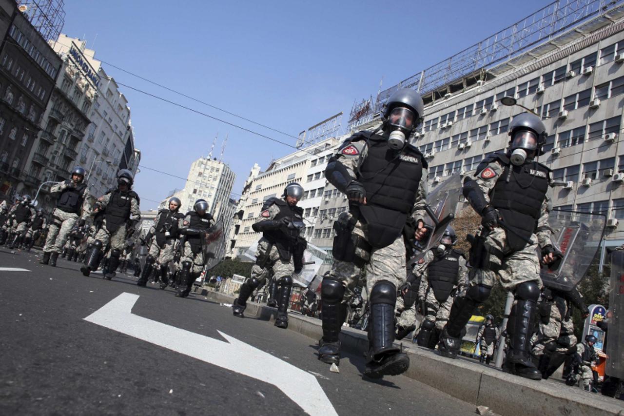 'Riot policemen run during clashes with anti-gay protesters in Belgrade October 10, 2010. A huge force of about 5,000 Serbian police clashed repeatedly with anti-gay protesters on Sunday, leading to a