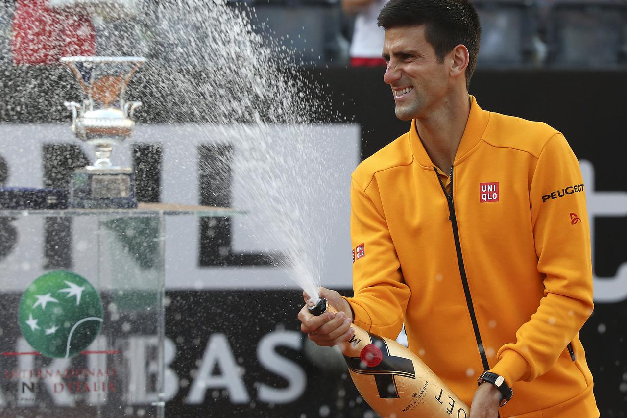 Novak Djokovic of Serbia sprays champagne after winning the final match over Roger Federer of Switzerland at the Rome Open tennis tournament in Rome, Italy, May 17, 2015. REUTERS/Stefano Rellandini