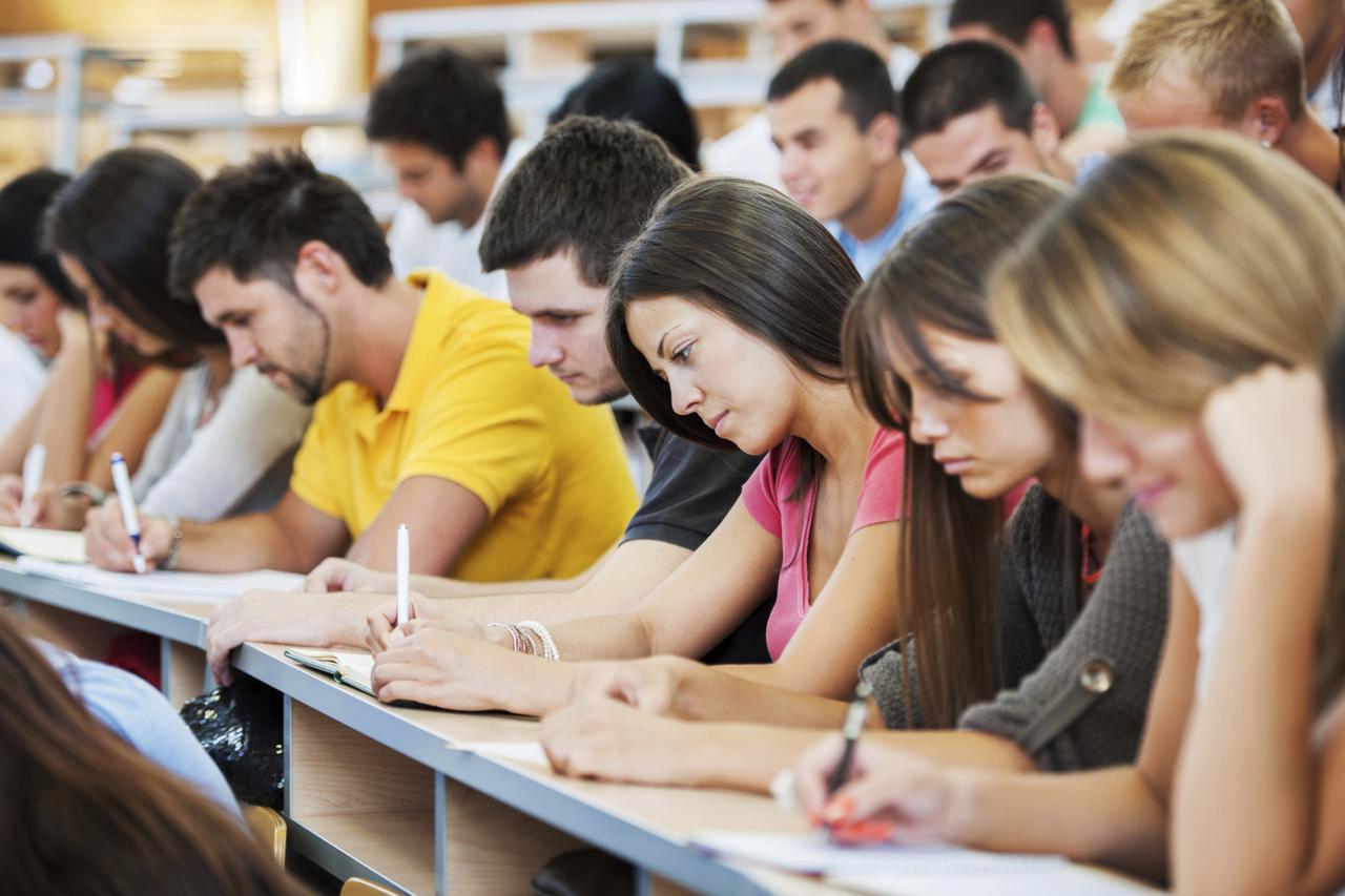 Large group of students writing.