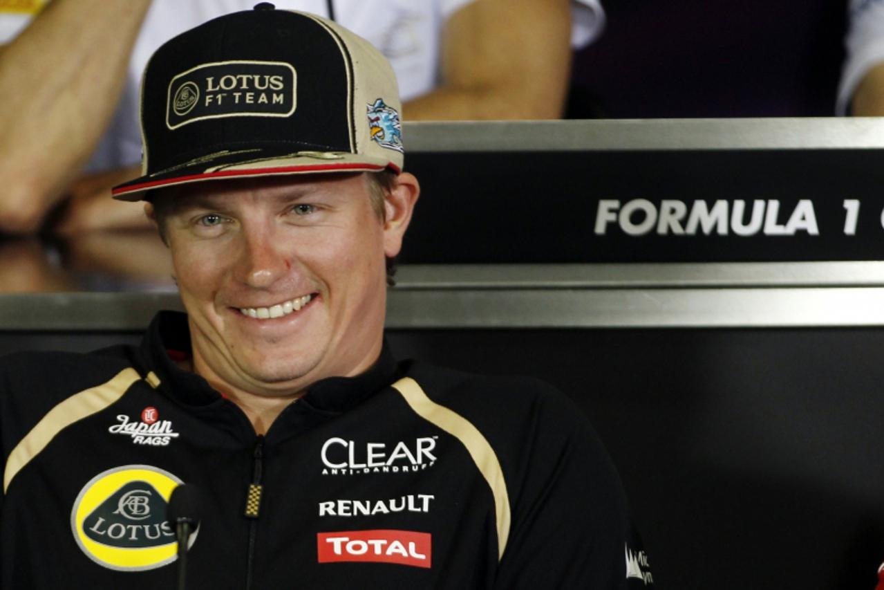 'Lotus F1 Formula One driver Kimi Raikkonen of Finland smiles during the news conference ahead of the Spanish F1 Grand Prix at Montmelo race track near Barcelona May 10, 2012.  REUTERS/Gustau Nacarino