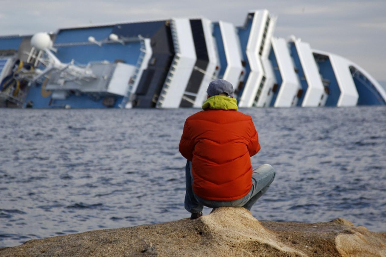 'The Costa Concordia cruise ship (rear) that ran aground off the west coast of Italy is seen at Giglio island January 18, 2012. Italian divers suspended their search of the capsized cruise liner Costa