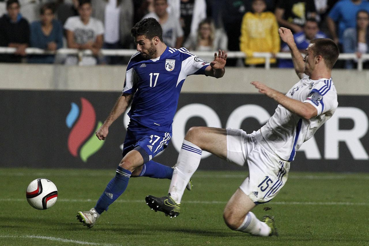 Cyprus' George Efrem fights for the ball with Bosnia's Toni Sunjic  during their Euro 2016 group B qualification match at the GSP stadium in Nicosia, Cyprus October 13, 2015. REUTERS/Yiannis Kourtoglou