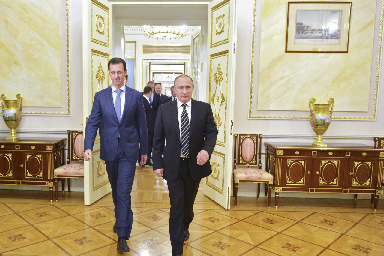 Russian President Vladimir Putin (R) and Syrian President Bashar al-Assad enter a hall during a meeting at the Kremlin in Moscow, Russia, October 20, 2015. Assad made a surprise visit to Moscow on Tuesday evening to thank Putin for launching air strikes a