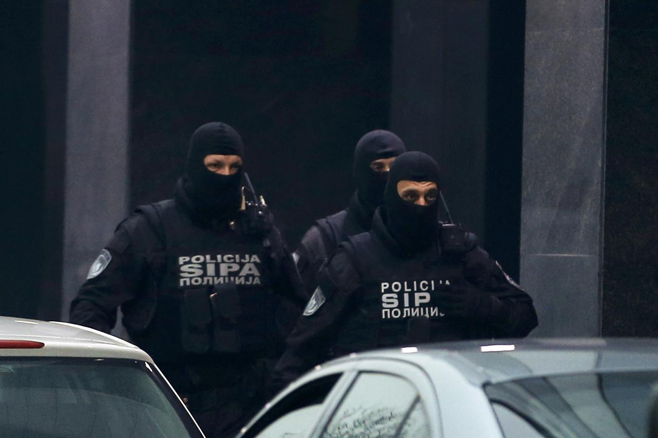 Members of Bosnia's State Investigation and Protection Agency (SIPA) stand outside the buliding of Dnevni Avaz newspaper in Sarajevo, Bosnia and Herzegovina, January 25, 2016. A Bosnian tycoon and head of a party in the ruling coalition was arrested on Mo