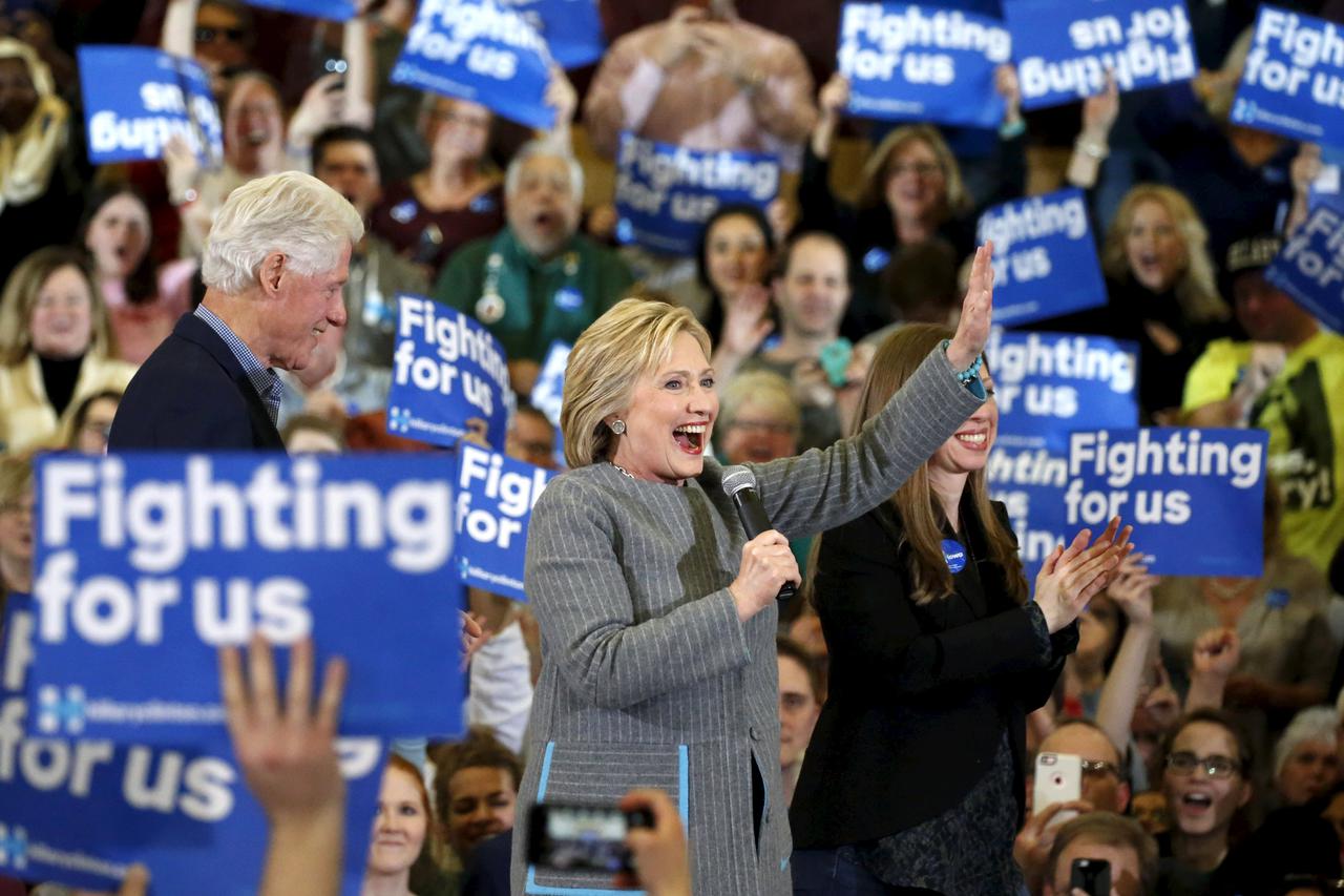 U.S. Democratic presidential candidate Hillary Clinton waves to supporters as she stands on stage with former U.S. President Bill Clinton and daughter Chelsea Clinton during a campaign rally at Abraham Lincoln High School in Des Moines, Iowa January 31, 2