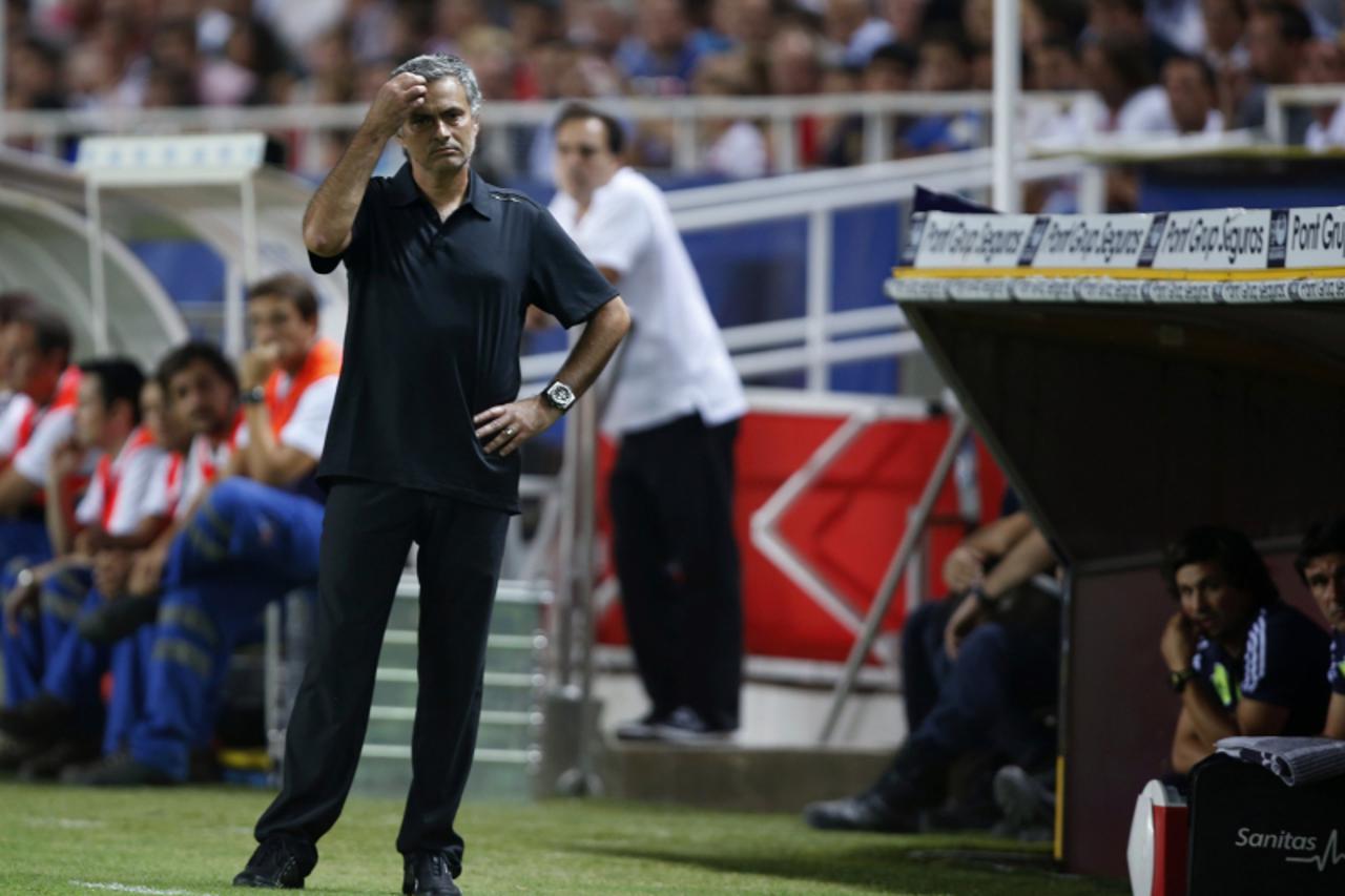 'Real Madrid's coach Jose Mourinho reacts during their Spanish First Division soccer match against Sevilla at Ramon Sanchez Pizjuan stadium in Seville September 15, 2012. REUTERS/Marcelo del Pozo (SP