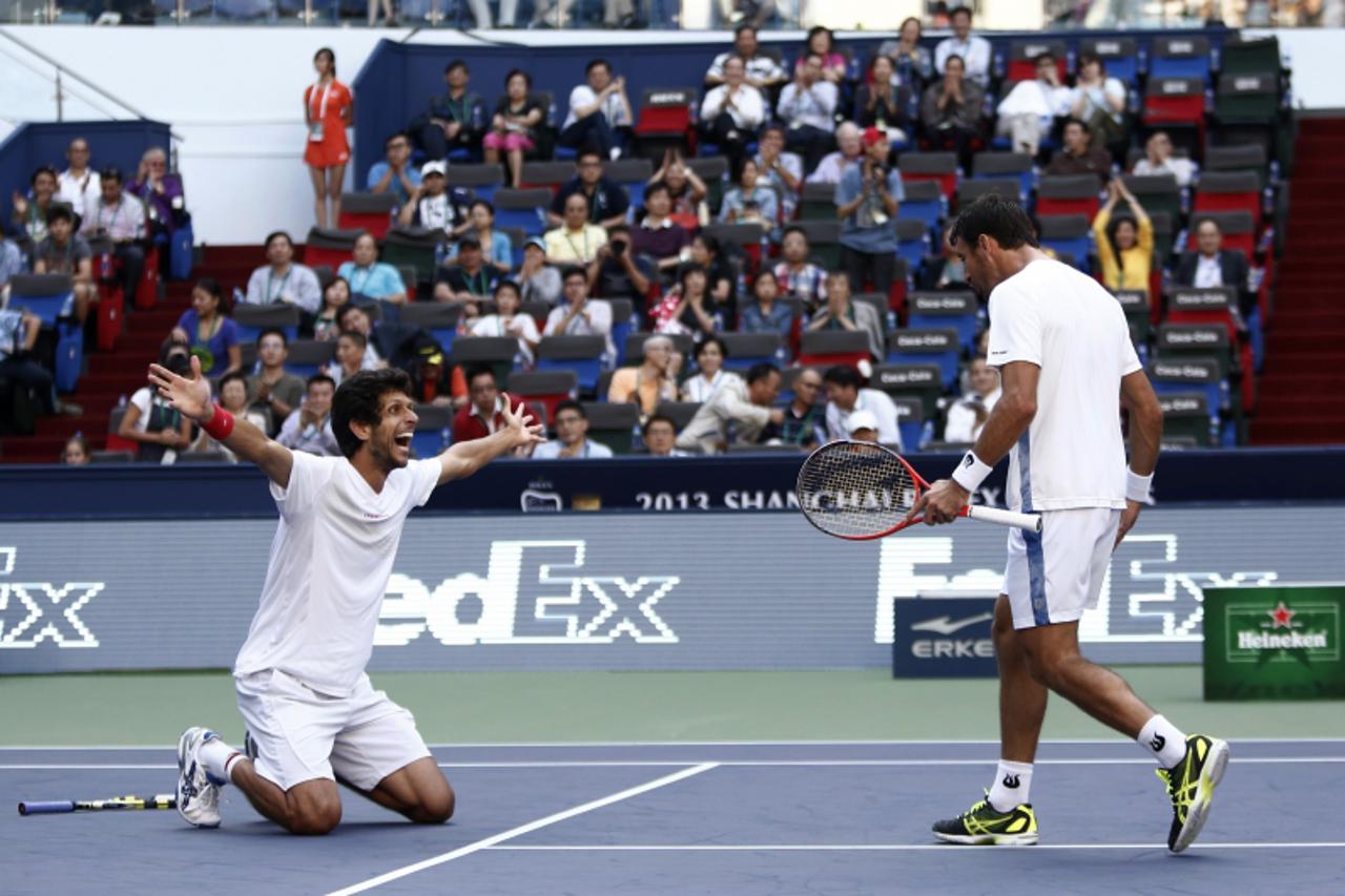 'Ivan Dodig (R) of Croatia and Marcelo Melo of Brazil celebrate after winning the men\'s doubles final against Fernando Verdasco and David Marrero of Spain at the Shanghai Masters tennis tournament Oc