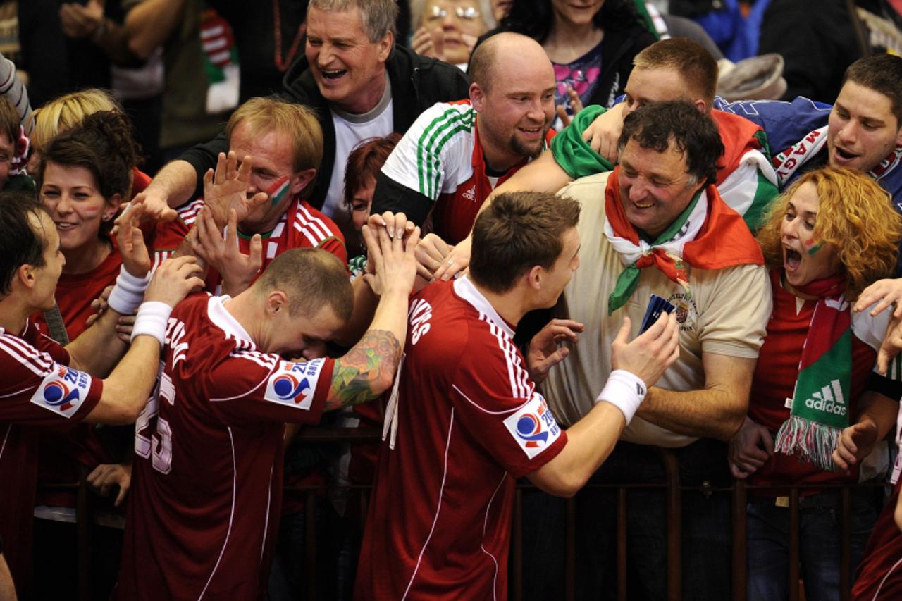 'Hungarian supporters congratulate Hungarian players on their victory over France during the Men\'s EHF Euro 2012 Handball Championship match between France and Hungary at the sports hall in Novi Sad 