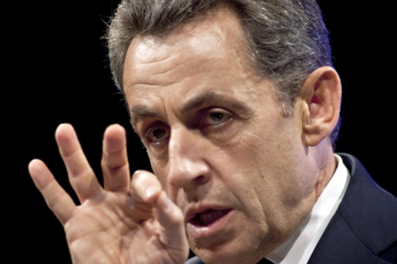 'France\'s President and UMP ruling party candidate for the 2012 French presidential elections Nicolas Sarkozy gestures as he gives a speech during a campaign meeting in Paris, on April 17, 2012.  POO