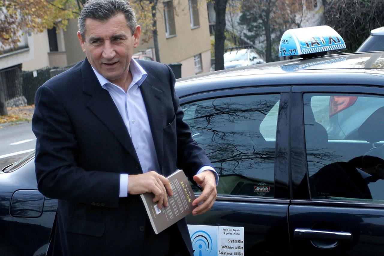 'Croatian ex-general Ante Gotovina stands in front of a taxi as he leaves his apartment in Zagreb on November 17, 2012, a day after he returned home as the ICTY dramatically cleared them of committing