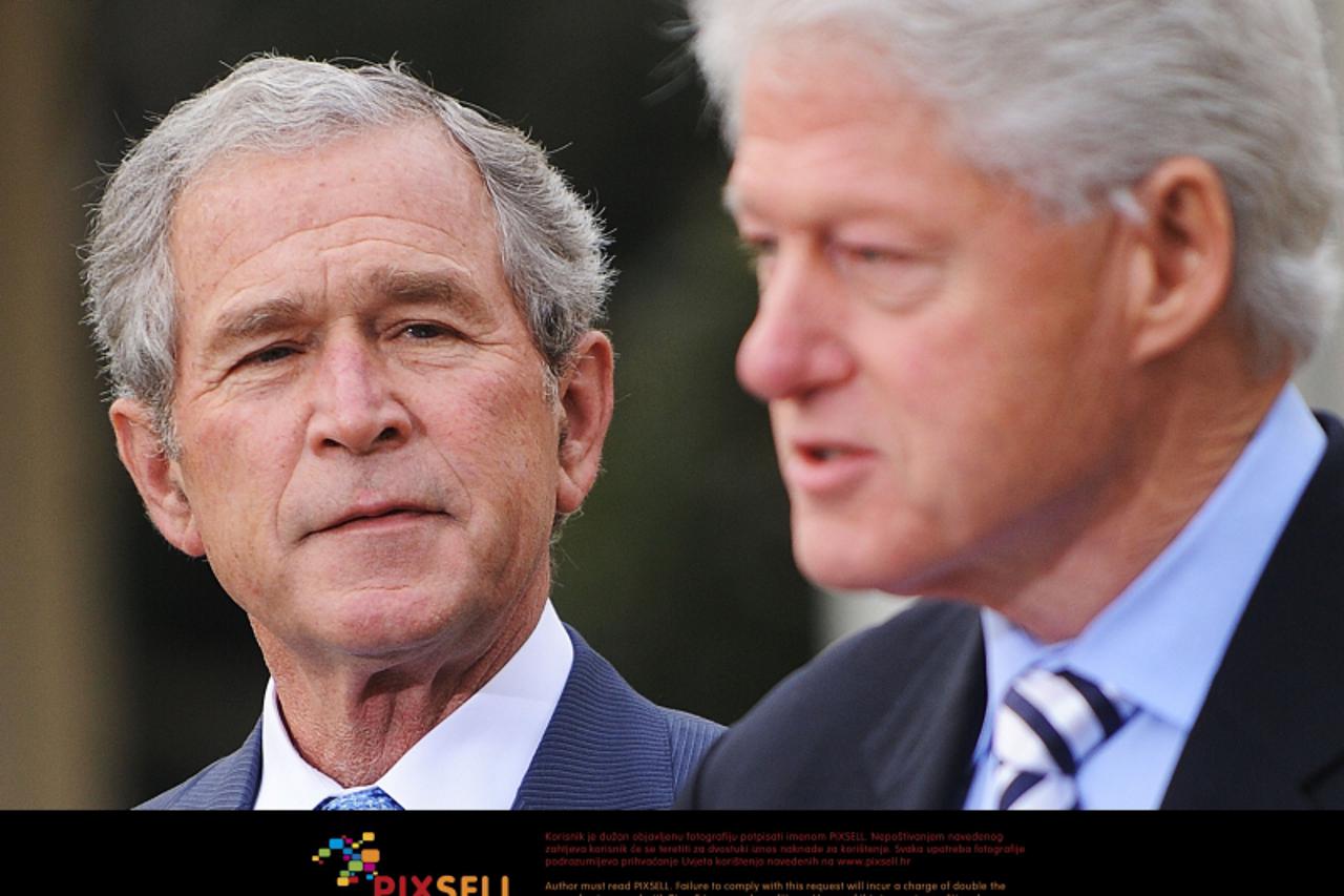 ' Former President Bill Clinton discusses the recovery and rebuilding effort in Haiti as former President George W. bush looks on in the Rose Garden on January 16, 2010 at the White House in Washingto