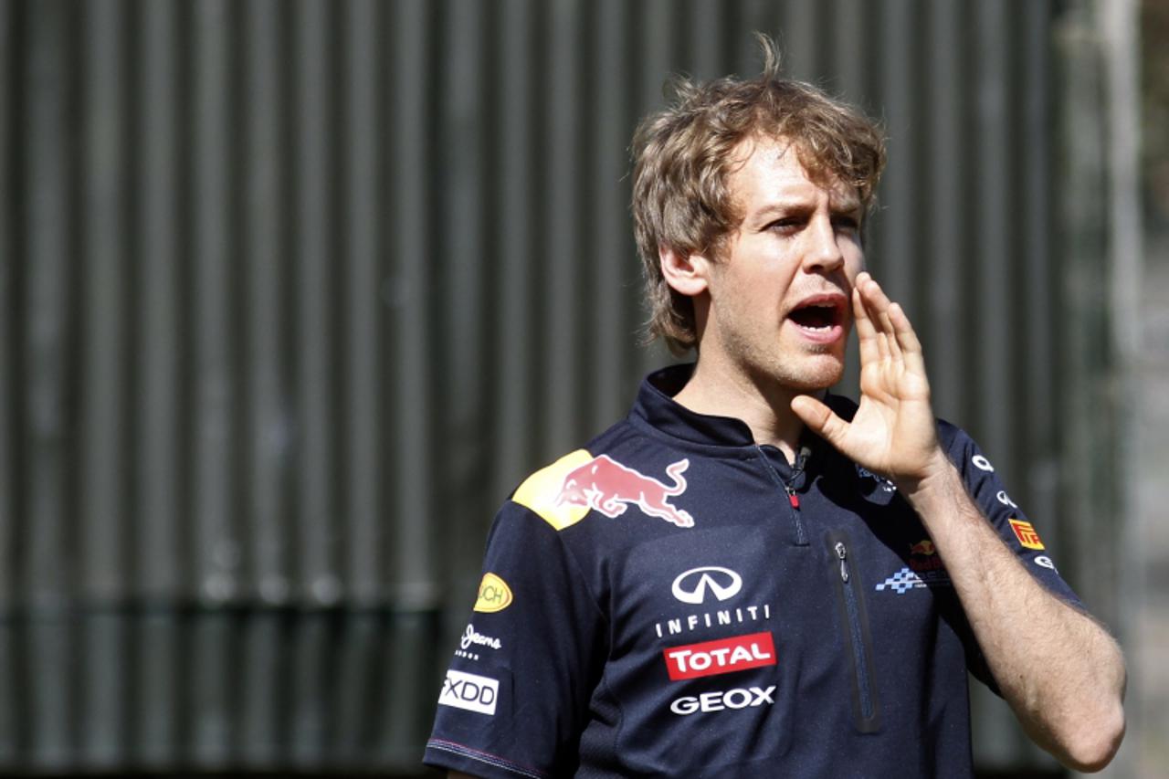 'Red Bull Formula One driver Sebastian Vettel of Germany calls out to a sheepdog during a media opportunity at a farm near Melbourne March 23, 2011. The Australian F1 race, to be held on March 27, is 