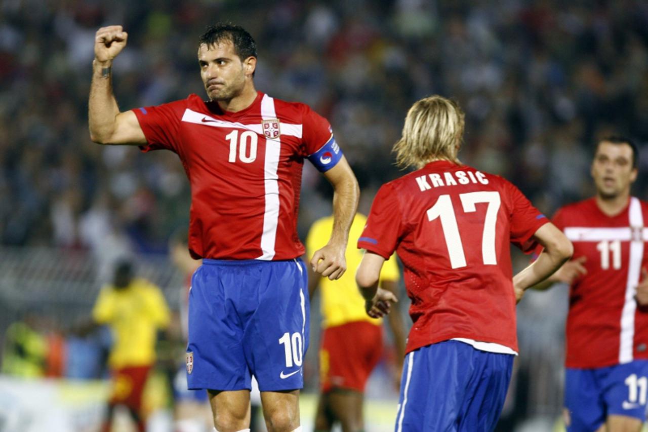 'Serbia's Dejan Stankovic (L) celebrates with team-mates Milos Krasic (C) and Nenad Milijas after scoring against Cameroon during their international friendly soccer match in Belgrade June 5, 2010.  