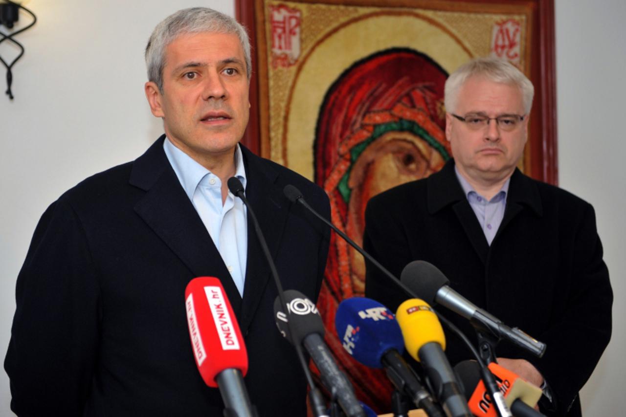 \'Serbian President Boris Tadic (L) speaks to the press as his Croatian counterpart Ivo Josipovic looks on during their visit to the orthodox monastery Krupa, near the southern Croatian town of Obrova