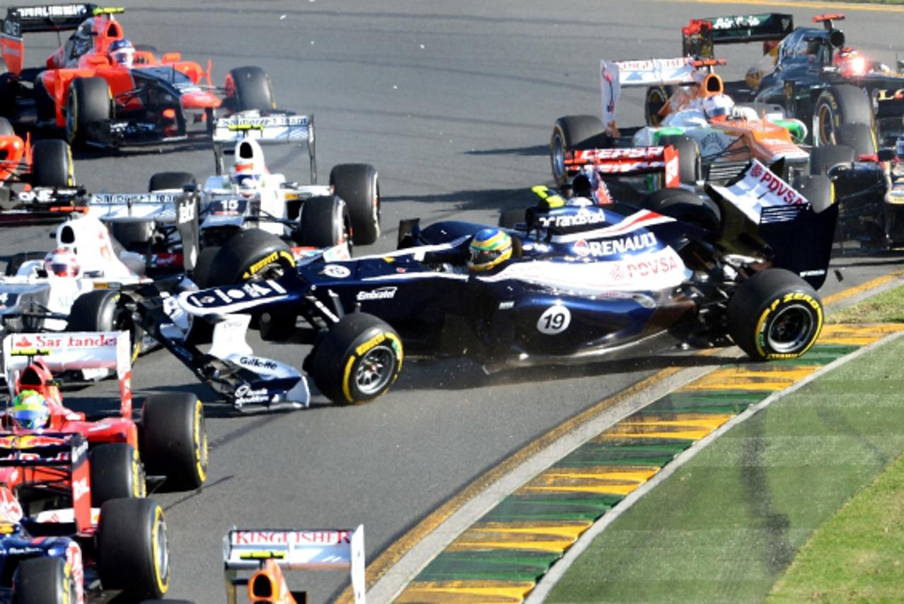 'Williams-Renault driver Bruno Senna of Brazil (C) is caught in an incident at the first turn in Formula One\'s Australian Grand Prix in Melbourne on March 18, 2012.    AFP PHOTO/William WEST '